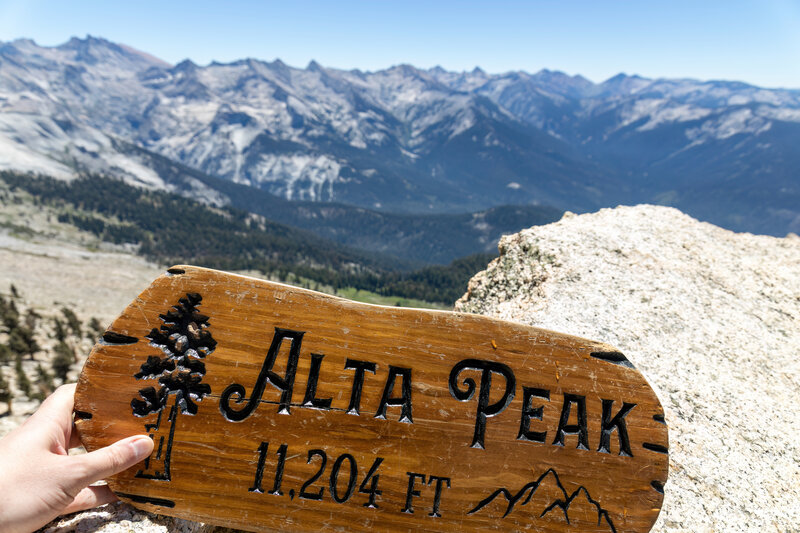 A wooden sign marks the top of Alta Peak