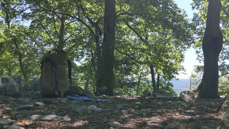 Backpack, trekking poles, and a view.