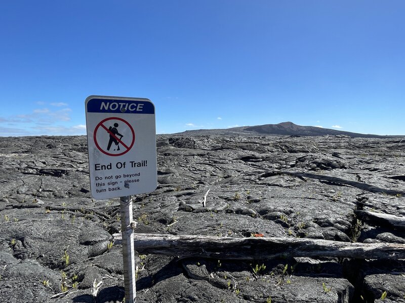 End of the trail sign, Pu'u O'o vent at a distance.