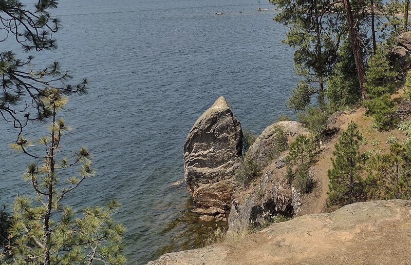 The crystal clear waters of Lake Coeur d'Alene at the foot of cliffs forming the shoreline along the south side of Tubbs Hill.