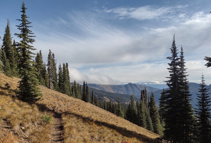 Heading out on Pend Oreille Divide Trail, high on a ridge, mounain views to the northeast give a hint of what's to come.