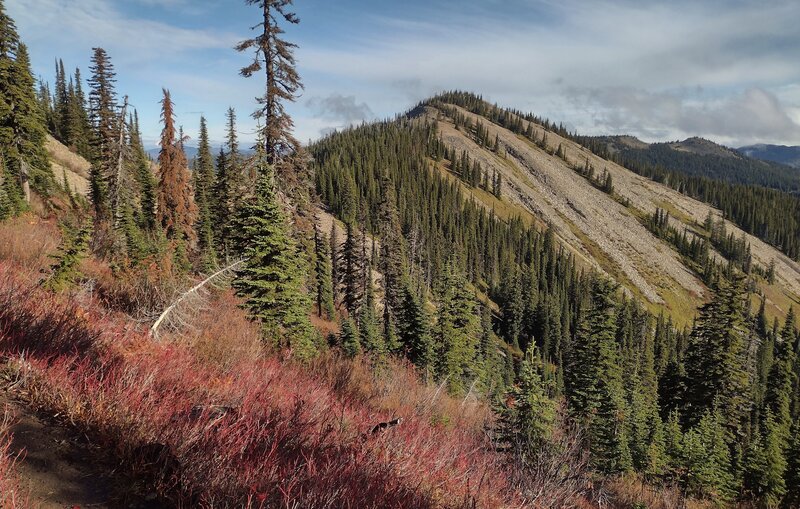 Nearby, imposing unnamed peak along the ridge to the north. The trail skirts around the west/left side of its summit.