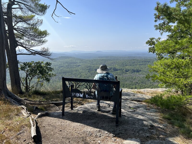 There is a bench at the summit of the mountain where you can sit and enjoy the views of the White Mountain Region.