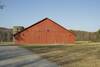 The trail passes to the left of the red barn on the property.