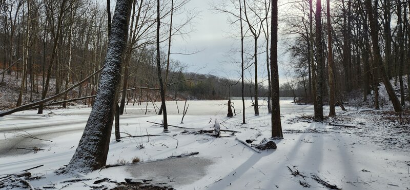 Coyote Hollow Lake in winter with snow and ice.