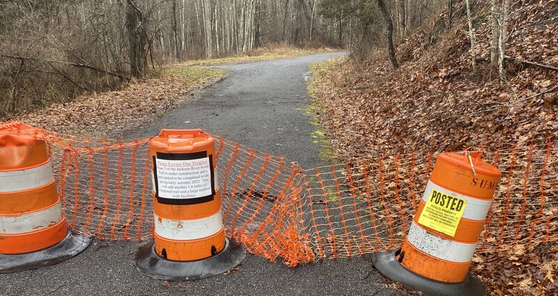 As of early 2024, the trail ends here. One sign says the trail extension should be completed in 2023, while the other clearly says no trespassing.