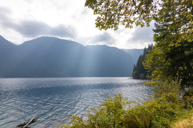 A few sun rays piercing a mostly overcast sky above Lake Crescent.