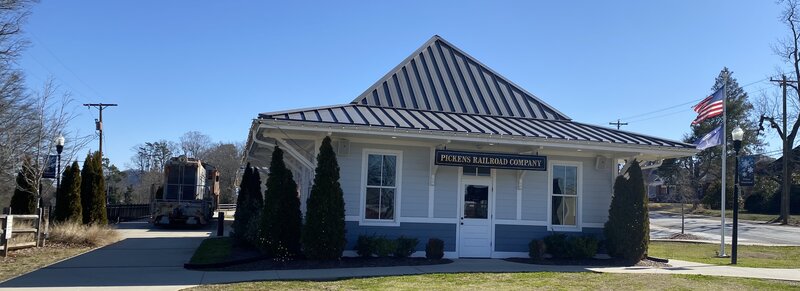 Pickens parking, restroom and diesel freight locomotive.