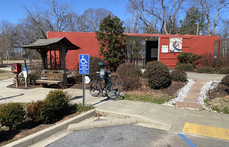 Easley parking lot with bike tools, water, accessibility and bath rooms (cleverly built into freight cars).