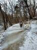 Crossing a slippery patch of ice covering the trail.