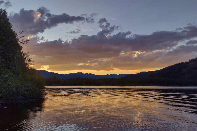 Northern Idaho sunset. Upper Priest Lake. Selkirk Mountains silhouetted against the golden sky. Seen looking northwest from Navigation trail camp.