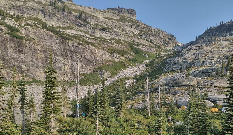 Fault Lake (lower left) reflecting the towering cliffs on a calm July evening. This is a popular place to camp. Follow Leave No Trace principles and be bear aware in this pristine spot.