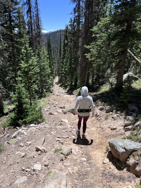 Descending the steep rocky trail below the lake