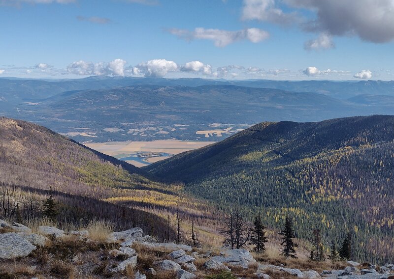 Kootenai River in its broad valley. Distant Purcell Mountains beyond. Seen looking east from Fisher Peak.