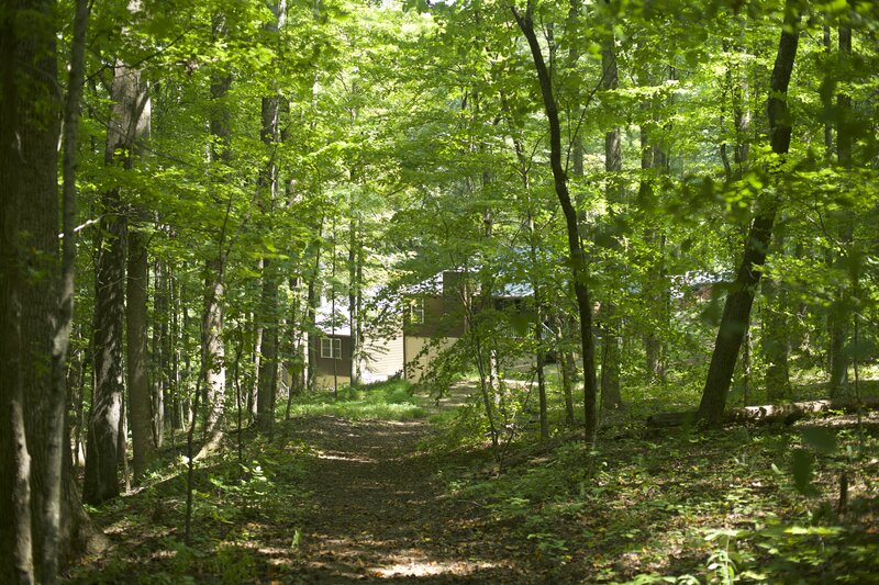 The trail emerges behind cabin 21 and 22 and provides access to the other cabins in the area.