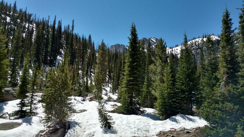 Yes, the trail goes up across that nearby low point for the final push to Alpine Lake, behind the low point.