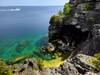 People swimming in the clear and colorful waters of the Grotto.