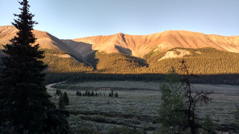 The southern end of the Starlight Range rises above frost covered willow meadows of the Rock Creek Valley, as the sun rises on a perfect, clear late August morning.