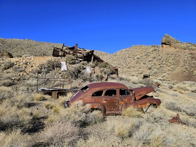A rusty 1946 Pontiac in the foreground with the old mill behind it.