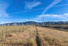 Following the fence line to the last few wind turbines.