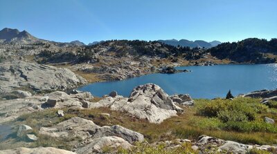 Cutthroat Lake. Looking east from above, on Doubletop Mountain Trail. In the far distance, highest peaks of the Wind Rivers "spine" poke up above the nearer hills.